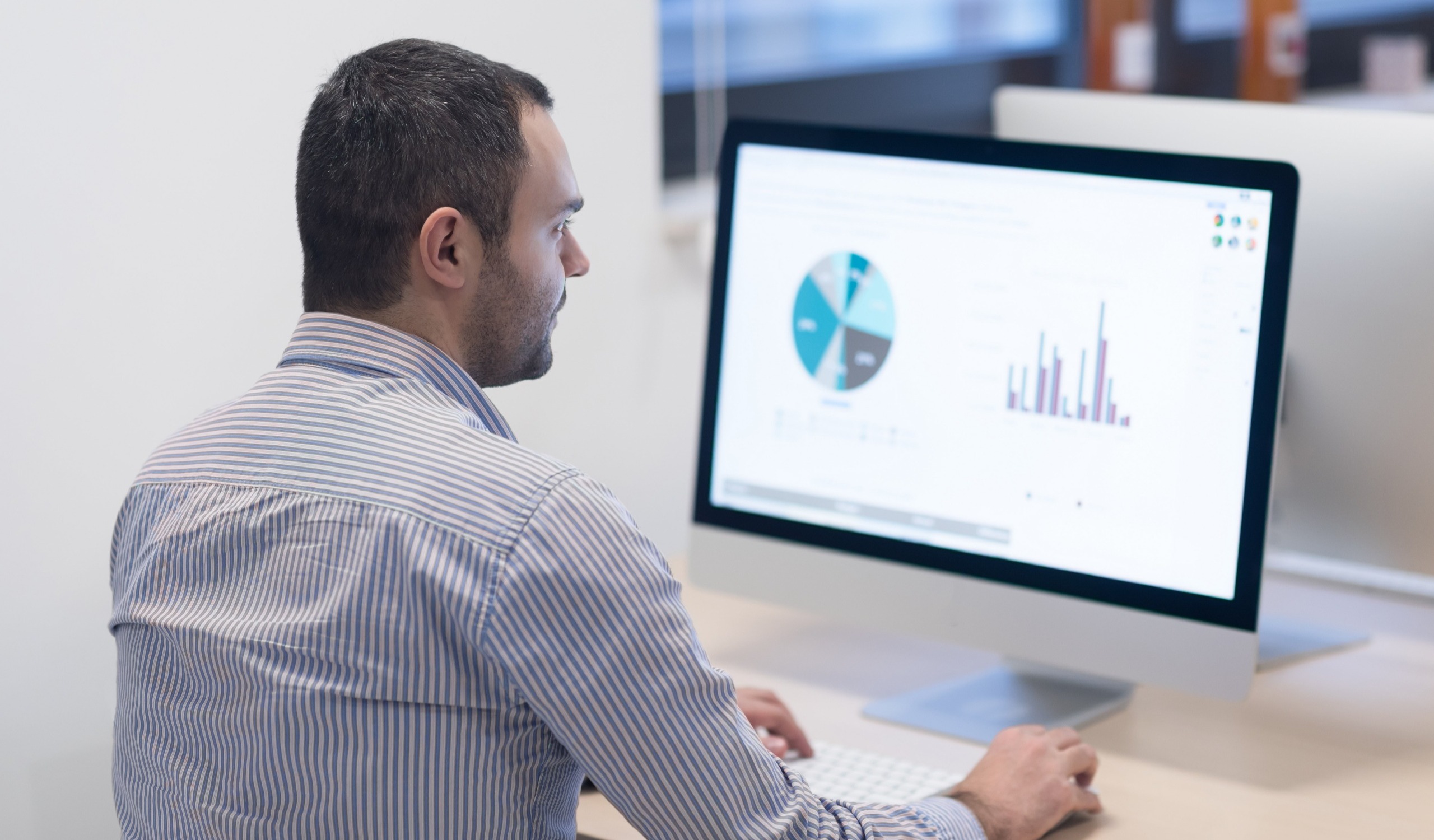 businessman reviewing data analytics on his computer